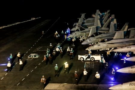 Sailors get ready for flight operations on the flight deck of USS Abraham Lincoln in Arabian Sea