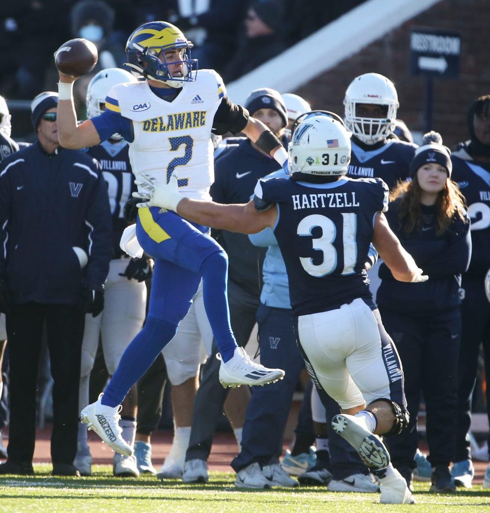 Delaware quarterback Nolan Henderson throws as he runs out of room against Villanova's Shane Hartzell in the second quarter at Villanova Stadium, Saturday, Nov. 19, 2022.