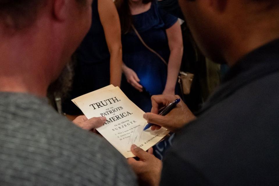 Ramaswamy signs a pamphlet while speaking to attendees at Jalapeno Pete's at the Iowa State Fair in Des Moines on Aug. 11, 2023.<span class="copyright">Stefani Reynolds—AFP/Getty Images</span>