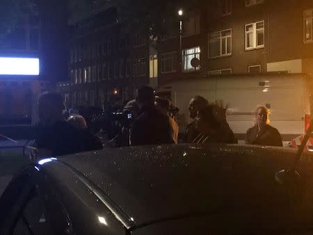 People gather at the scene where police are investigating a van (not pictured) with Spanish licence plates containing gas bottles that was found near a concert hall in Rotterdam, in this handout picture obtained by Reuters August 23, 2017. Social Media/Handout via REUTERS