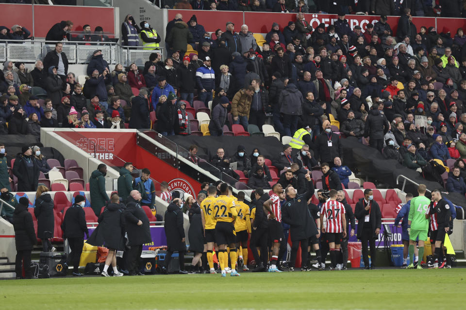 Players are escorted from the field as a drone is spotted on the stadium during the English Premier League soccer match between Brentford and Wolverhampton Wanderers at the Brentford Community Stadium in Brentford, England Saturday, Jan. 22, 2022. (AP Photo/Ian Walton)