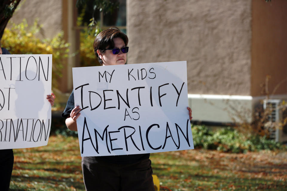 FILE - People protest outside the offices of the New Mexico Public Education Department's office, Nov. 12, 2021, in Albuquerque, N.M. The education department proposed changes to the social studies curriculum that critics describe as a veiled attempt to teach critical race theory. Supporters say the new curriculum, which includes ethnic studies, is "anti-racist." (AP Photo/Cedar Attanasio, File)