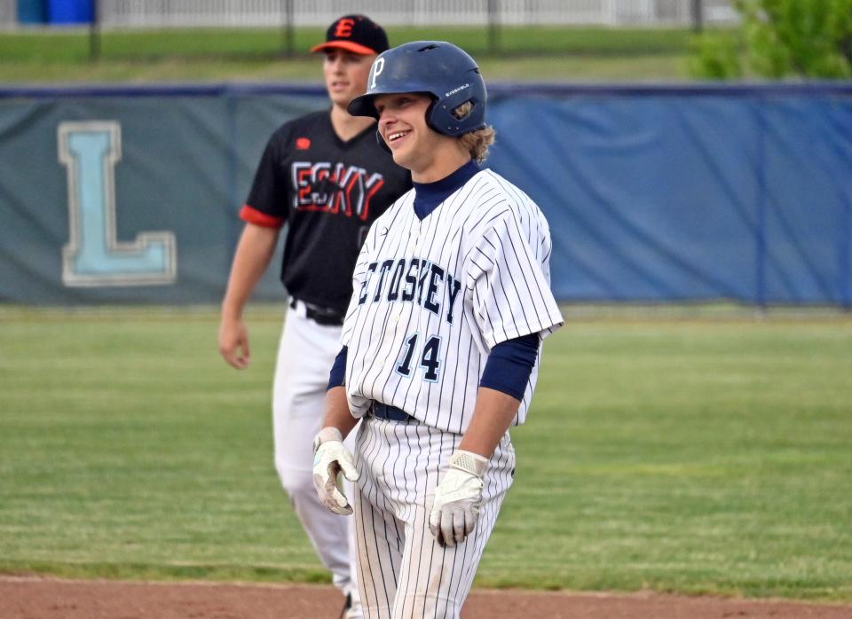 Petoskey's Brendan Swiss looks back and smiles at the dugout as his teammates celebrate his two-RBI single late in Thursday's game.