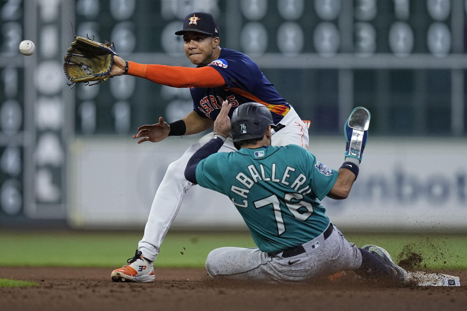 Seattle Mariners' Jose Caballero (76) steals second base against Houston Astros shortstop Jeremy Pena during the fifth inning of a baseball game, Saturday, Aug. 19, 2023, in Houston. (AP Photo/Kevin M. Cox)