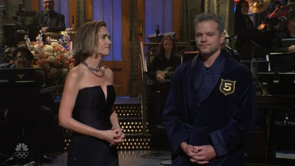 In an attempt to make her feel better, Damon points out that Wiig is the youngest member to join the club as well as the first female to join and Wiig points out that Emma Stone had been inducted before her and there are several women in the club. NBC / SNL