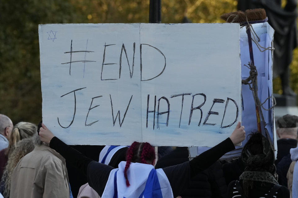 An Israeli supporter holds up a placard saying 'End Jew Hatred' as she takes part in a protest where placards with the faces and names of people believed taken hostage and held in Gaza were held up during a protest in Trafalgar Square, London, Sunday, Oct. 22, 2023. (AP Photo/Frank Augstein)