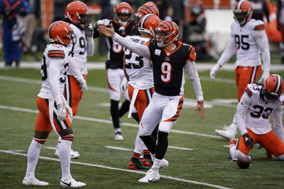 Cincinnati Bengals quarterback Joe Burrow (9) reacts after running for a first down during the second half of an NFL football game against the Cleveland Browns, Sunday, Oct. 25, 2020, in Cincinnati. (AP Photo/Michael Conroy)