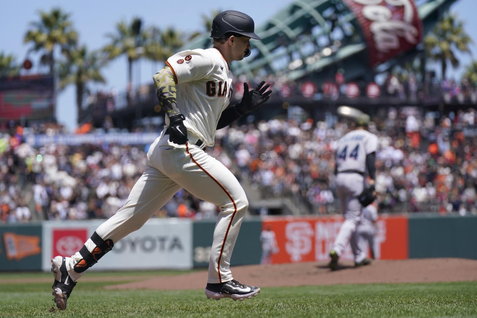 San Francisco Giants' Patrick Bailey rounds the bases after hitting a home run off Miami Marlins pitcher Jesus Luzardo, rear, during the second inning of a baseball game in San Francisco, Sunday, May 21, 2023. (AP Photo/Jeff Chiu)