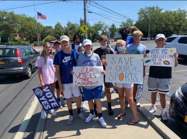 Students rallied at the traffic circle in Riverhead, asking voters to pass the budget and save programs. / Courtesy Andrew MacGray.