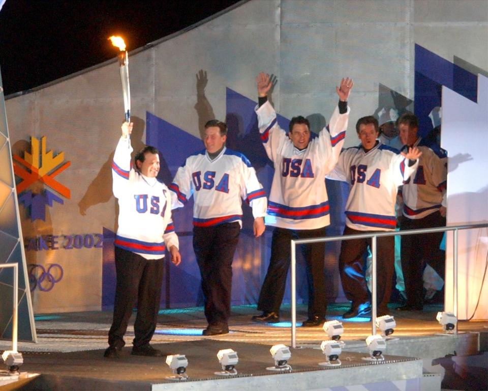 The 1980 U.S. hockey team lights the cauldron during the Salt Lake 2002 Winter Games opening ceremony at the University of Utah’s Rice-Eccles Stadium on Friday, Feb. 8, 2002. | Johanna Kirk, Deseret News