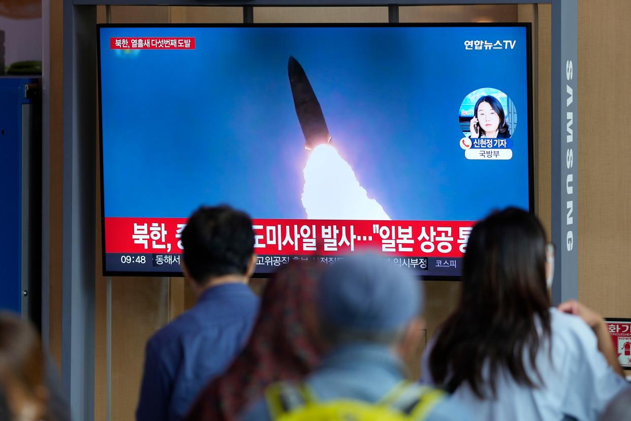 A TV screen showing a news program reporting about North Korea's missile launch with file footage, is seen at the Seoul Railway Station in Seoul, South Korea, Tuesday, Oct. 4, 2022.