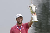 Jon Rahm, of Spain, holds the champions trophy for photographers after the final round of the U.S. Open Golf Championship, Sunday, June 20, 2021, at Torrey Pines Golf Course in San Diego. (AP Photo/Jae C. Hong)