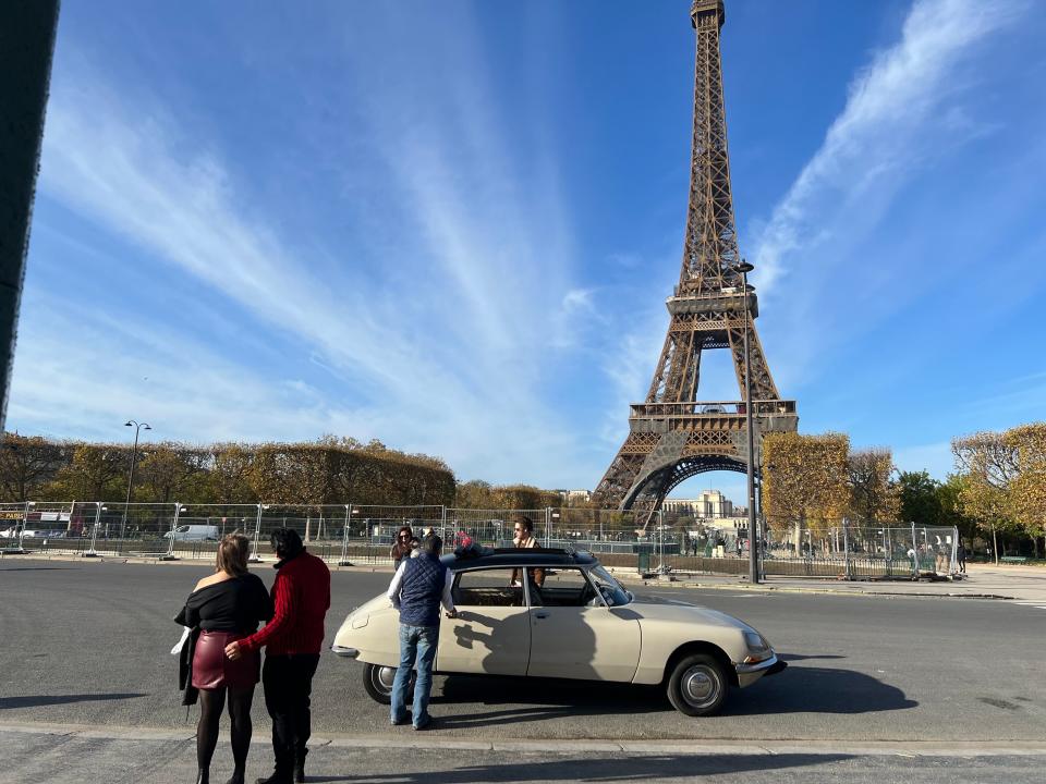 A car in front of the Eiffel Tower.