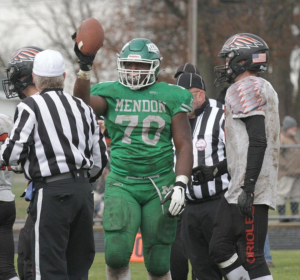 Khayvien Brown of Mendon showcases the football after recovering a fumble for the Hornets on Saturday.