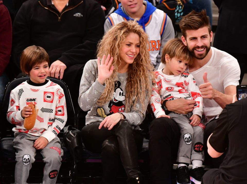 Shakira, Gerard, and their two children sitting together