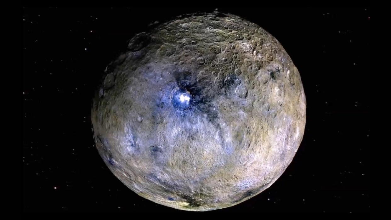  A silver-and-grey round rock in space. 