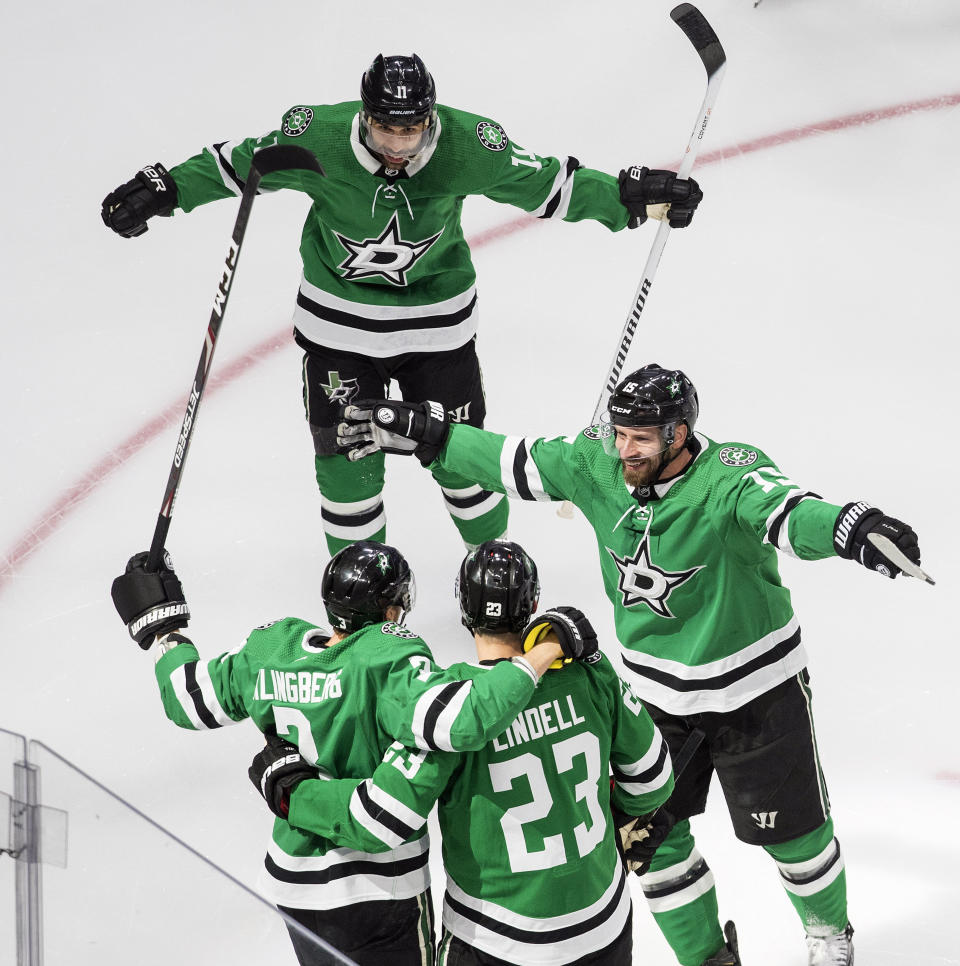 Dallas Stars players celebrate a goal by John Klingberg against the Colorado Avalanche during the first period of an NHL hockey second-round playoff series, Sunday, Aug. 30, 2020, in Edmonton, Alberta. (Jason Franson/The Canadian Press via AP)