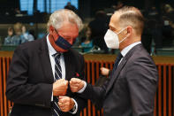 Luxembourg's Foreign Minister Jean Asselborn, left, greets German's Foreign Minister Heiko Maas during a European Foreign Affairs Ministers meeting at the European Council building in Luxembourg, Monday, June 21, 2021. EU foreign ministers were set to approve Monday a new set of sanctions against scores of officials in Belarus and prepare a series of measures aimed at the country's economy. (Johanna Geron/Pool Photo via AP)