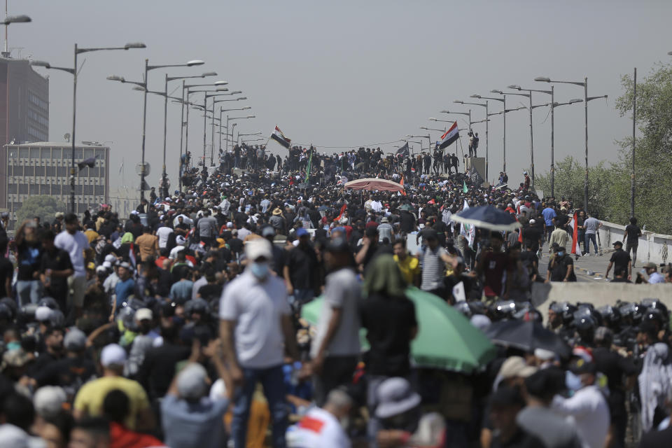 Protesters gather a bridge leading to the Green Zone area in Baghdad, Iraq, Saturday, July 30, 2022 — days after hundreds breached Baghdad's parliament Wednesday chanting anti-Iran curses in a demonstration against a nominee for prime minister by Iran-backed parties.(AP Photo/Anmar Khalil)