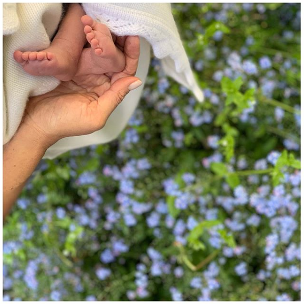 A photo of the Duchess of Sussex cradling the feet of her newborn son Archie Mountbatten.