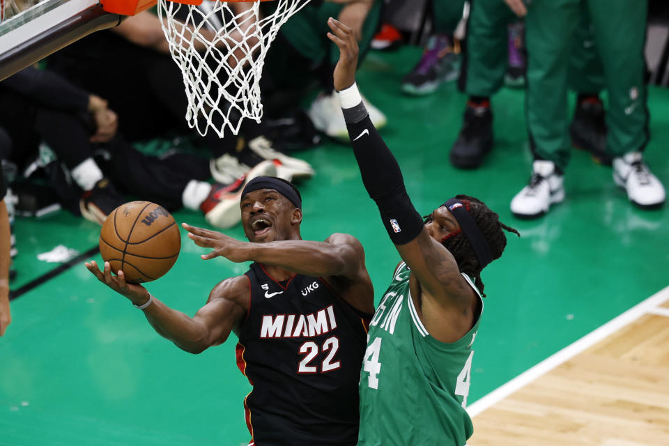 Miami Heat forward Jimmy Butler, left, shoots as Boston Celtics center Robert Williams III defends during the second half in Game 7 of the NBA basketball Eastern Conference finals Monday, May 29, 2023, in Boston. (AP Photo/Michael Dwyer)