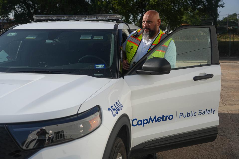 Public safety ambassador Joel Salinas steps into his patrol vehicle at the start of his shift outside the CapMetro Public Safety Program office. The transit agency's public safety ambassadors are unarmed, uniformed civilians trained in de-escalation tactics.
