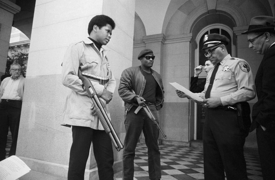 Two members of the Black Panther Party with Ernest Holloway