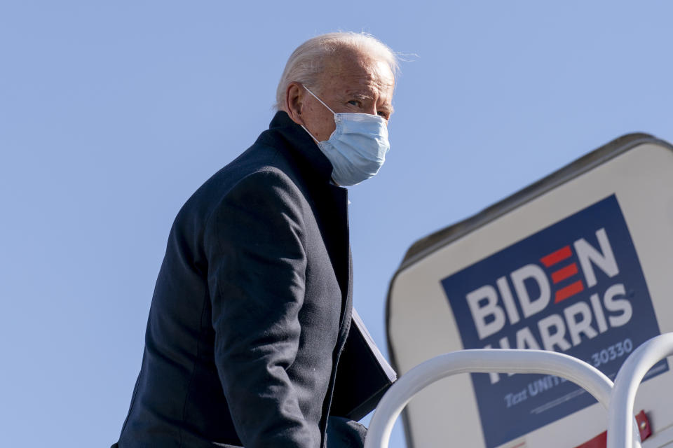 FILE - Democratic presidential candidate former Vice President Joe Biden boards his campaign plane in Wilmington, Del., Monday, Nov. 2, 2020, to travel to Cleveland for a rally. When Joe Biden was running for president three years ago, he flew on a white private jet with his campaign logo painted on the side. Now he has a larger, more recognizable ride as he seeks a second term. Like his predecessors, he'll be crisscrossing the country on Air Force One. (AP Photo/Andrew Harnik, File)