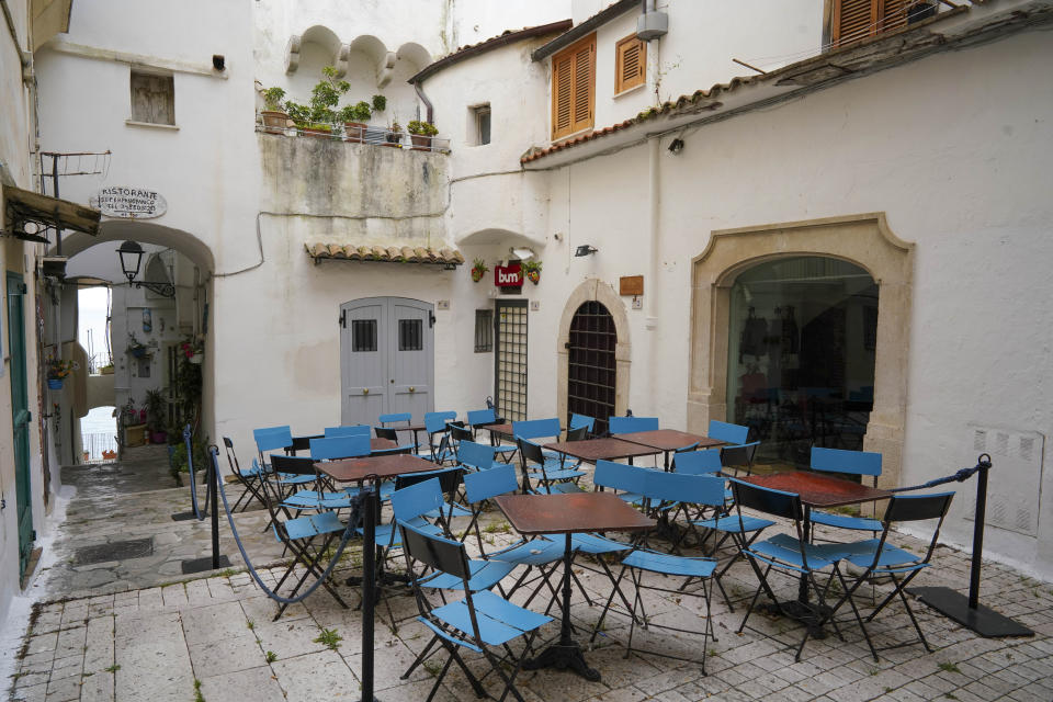 In this picture taken on Tuesday, April 28, 2020, tables and chairs are seen in front of a closed restaurant, in the seaside town of Sperlonga, some 120km (80 miles) south of Rome. Normally, at this time of year Sperlonga would already be bustling with its first clients of the season. The restaurants would be fully operational and the golden-sand beaches, although still too chilly for Italians, would have been enjoyed by northern Europeans eager for some sunlight after a long, dark winter. (AP Photo/Andrew Medichini)