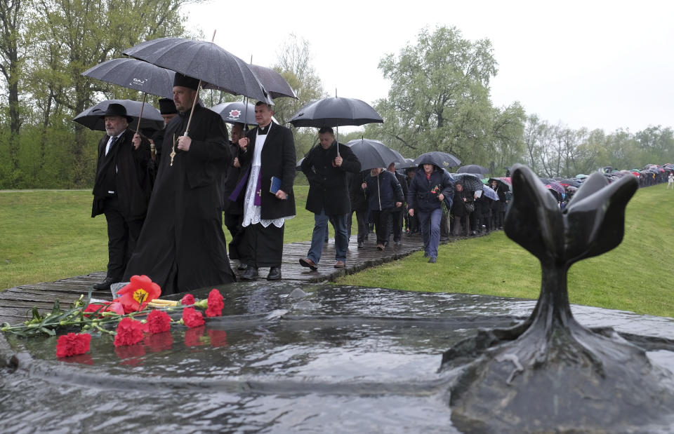 Hundreds gather at the memorial center to pay their respects for tens of thousands of people killed in death camps run by Croatia's pro-Nazi puppet state in WWII, in Jasenovac, Croatia, Friday, April 12, 2019. Croatia's Jewish, Serb, anti-fascist and Roma groups have commemorated the victims of a World War II death camp, snubbing the official ceremonies for the fourth year in a row over what they say is government inaction to curb neo-Nazi sentiments in the European Union country. (AP Photo/Nikola Solic)