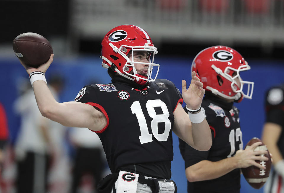 Georgia quarterback JT Daniels (18) and Stetson Bennett prepare to play Cincinnati in the NCAA college football Peach Bowl game on Friday, Jan. 1, 2021, in Atlanta. (Curtis Compton/Atlanta Journal-Constitution via AP)