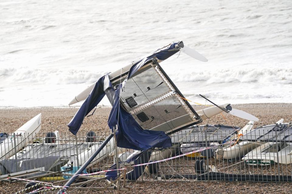 A catamaran washed up along the seafront in Brighton (Adam Davy/PA) (PA Wire)