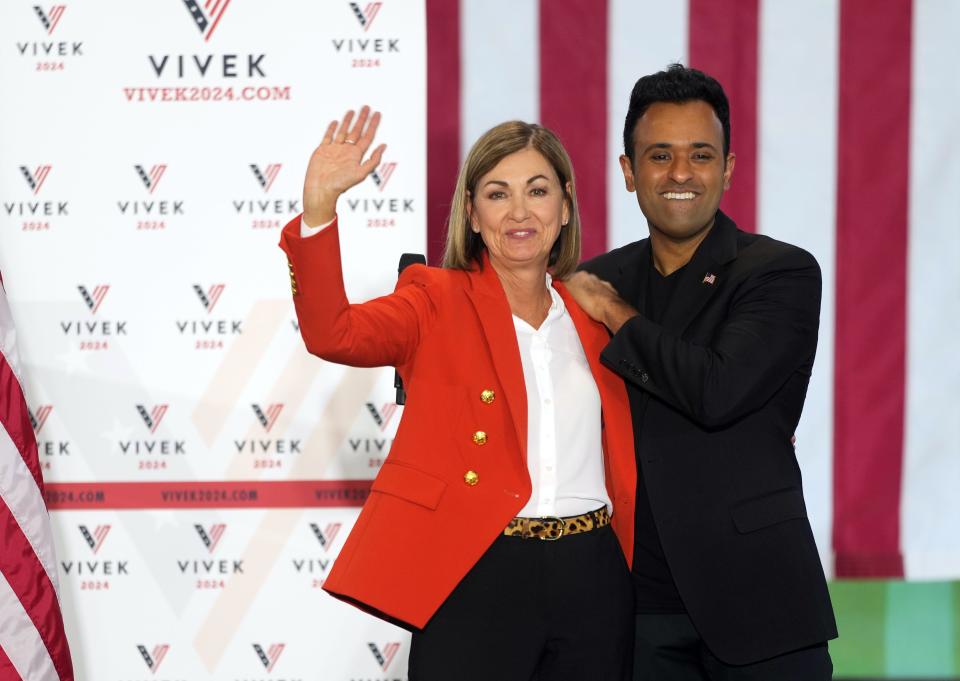 Iowa Gov. Kim Reynolds, left, introduces Republican presidential candidate Vivek Ramaswamy during a campaign rally in Urbandale, Thursday, May 11, 2023. 
