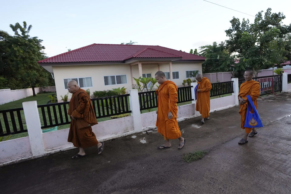 Buddhist monks walk in front of former childcare center before the Buddhist ceremony in the rural town of Uthai Sawan, in Nong Bua Lamphu province, northeastern Thailand, Friday, Oct. 6, 2023. A memorial service takes place to remember those who were killed in a grisly gun and knife attack at a childcare center. A former police officer killed 36 children and teachers in the deadliest rampage in Thailand's history one year ago. (AP Photo/Sakchai Lalit)
