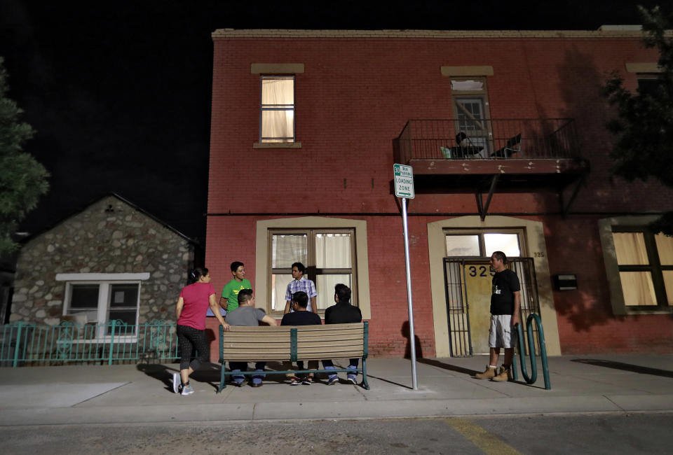 FILE - Migrant parents socialize outside the Annunciation House, June 26, 2018, in El Paso, Texas. On Monday, March 11, 2024, a Texas judge ruled in favor of Annunciation House, a large migrant shelter on the U.S.-Mexico border that Republican Attorney General Ken Paxton is seeking to shut down over claims that the facility encourages migrants to enter the country illegally. (AP Photo/Matt York, File)