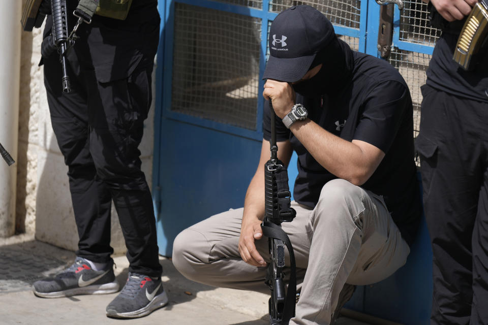 Armed Palestinians mourn during the funeral of Amjad al-Fayyed, 17, in the West Bank refugee camp of Jenin, Saturday, May 21, 2022. Israeli troops shot and killed al-Fayyed as fighting erupted when soldiers entered a volatile town in the occupied West Bank early Saturday, the Palestinian health ministry and local media said. (AP Photo/Majdi Mohammed)