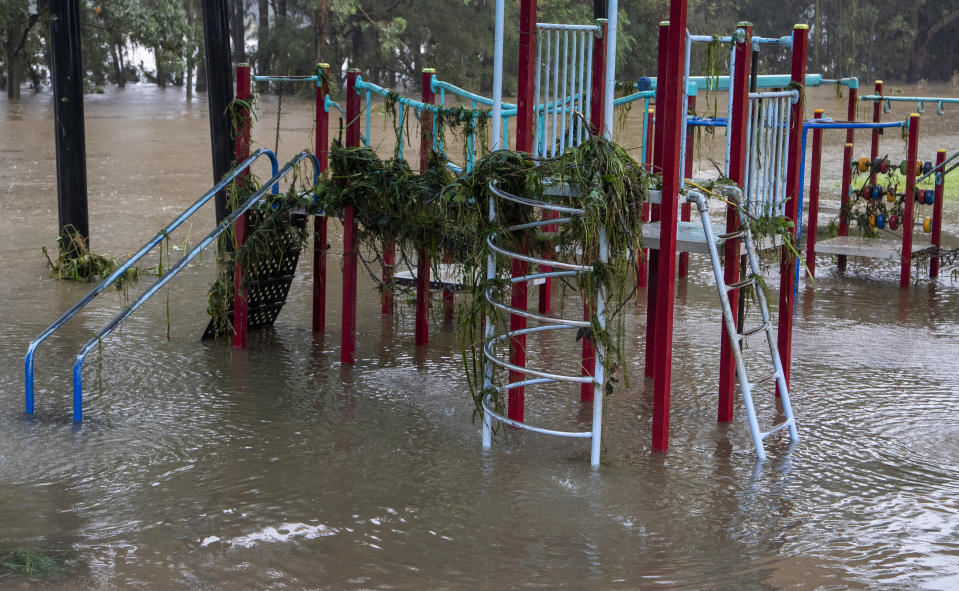 Debris rests on playground equipment as water levels subside on the banks of the Nepean River at Jamisontown on the western outskirts of Sydney Monday, March 22, 2021. Australia's most populous state of New South Wales has issued more evacuation orders following the worst flooding in decades. (AP Photo/Mark Baker)