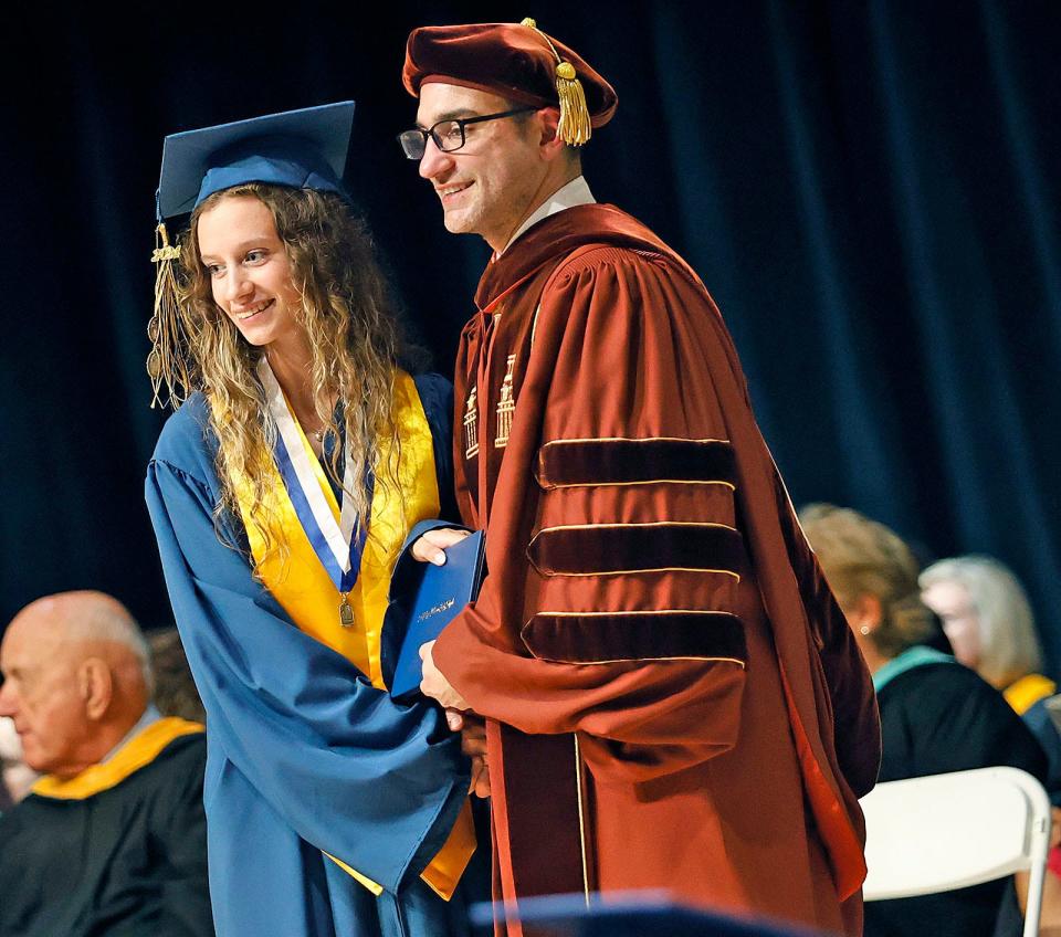 Lorelai Banville receives her diploma from Principal Michael Volonnino during Archbishop Williams High School's graduation on Thursday, May 23, 2024.
