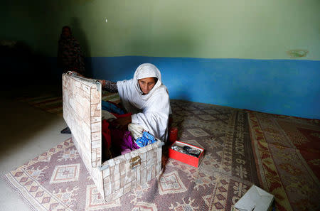 Shehreen, aunt of Ambreen Riasat, shows her belongings in their home in the village of Makol outside Abbottabad, Pakistan May 6, 2016. REUTERS/Caren Firouz TPX IMAGES OF THE DAY