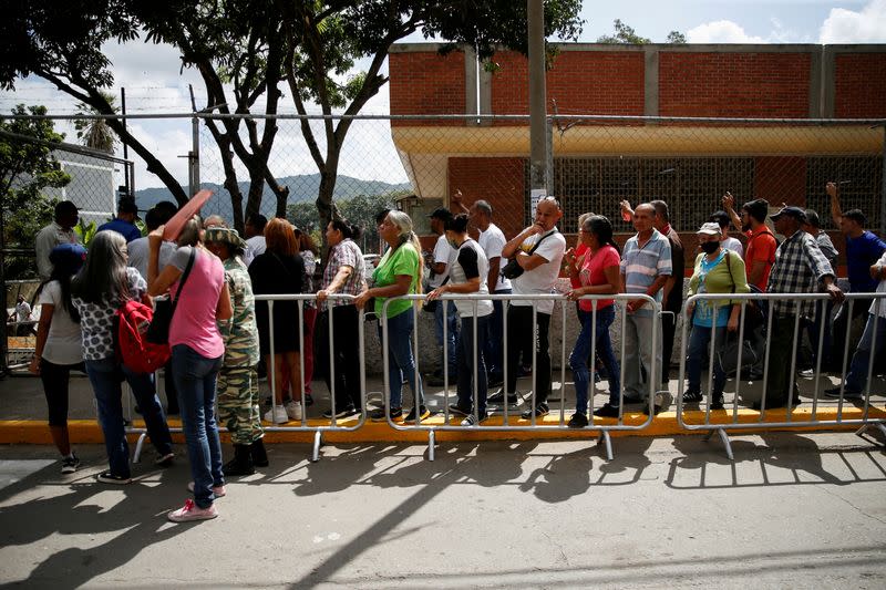 FILE PHOTO: Venezuelans participate in an electoral simulation of a referendum over disputed territory, in Caracas