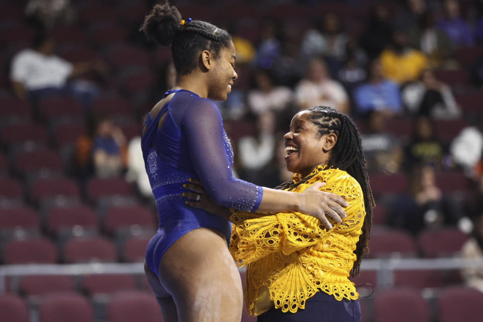 Fisk University coach Corrinne Tarver, right, embraces Kiara Richmon after her balance-beam performance during a Super 16 gymnastics meet on Jan. 6, in Las Vegas.  / Credit: Chase Stevens / AP
