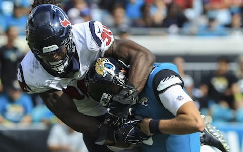 Cody Kessler #6 of the Jacksonville Jaguars is tackled by Jadeveon Clowney #90 of the Houston Texans during the second half at TIAA Bank Field on October 21, 2018 in Jacksonville, Florida - Credit: Getty Images 