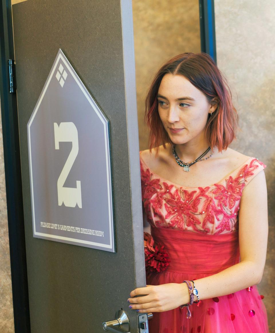 Saoirse opening a door