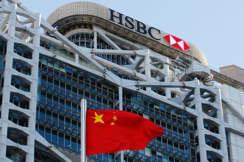 FILE PHOTO: A Chinese national flag flies in front of HSBC headquarters in Hong Kong