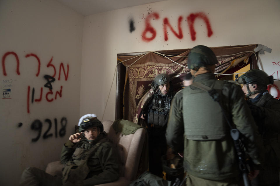 Israeli soldiers stand inside a building during the ground offensive on the Gaza Strip in Khan Younis, Saturday, Jan. 27, 2024. (AP Photo/Sam McNeil)