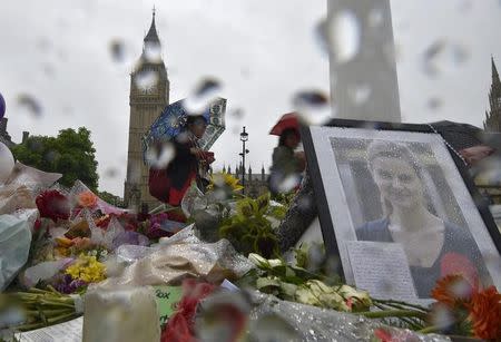 People view tributes in memory of murdered Labour Party MP Jo Cox, who was shot dead in Birstall, at Parliament Square in London, Britain June 20, 2016. REUTERS/Toby Melville/Files