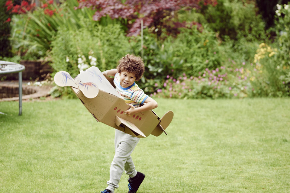 Boy playing with homemade plane in a bid to cut costs of raising a child.