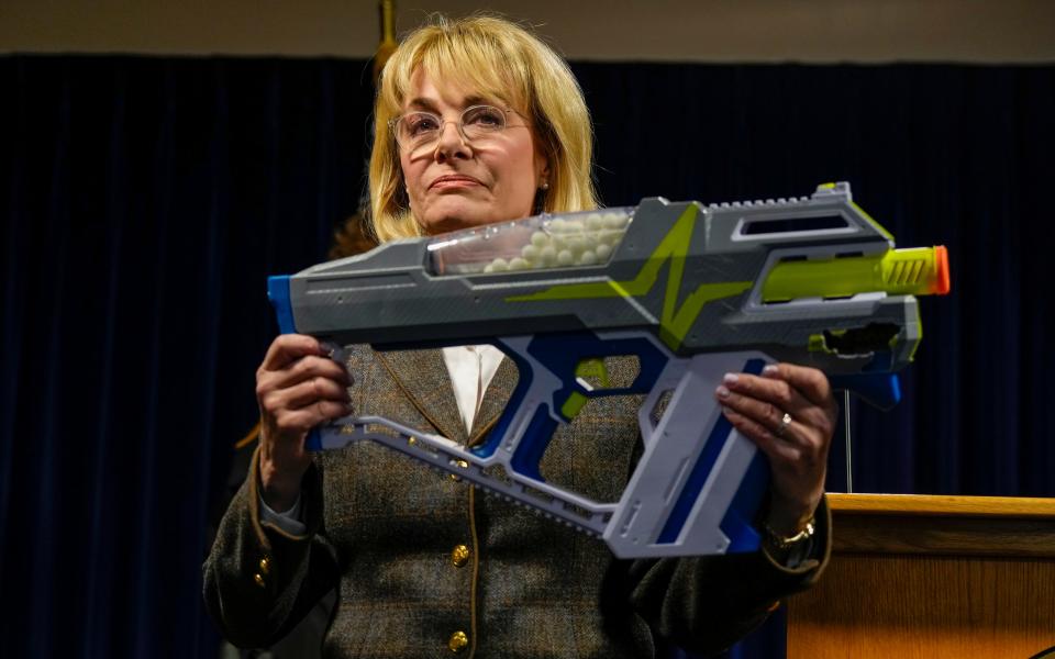 Melissa Powers, Hamilton County prosecutor shows a Nerf gun Thursday, March 16 while announcing that Joe Mixon's sister, Shalonda Mixon and her boyfriend, Lamonte Brewer, have been indicted in connection to a shooting in Anderson Township. Powers said multiple juveniles were playing dart wars and that Brewer and others should have been able to tell that the juveniles were carrying toy weapons. Shots were fired and a 16-year-old was injured on Ayers Road on the night of March 6.