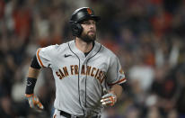 San Francisco Giants' Brandon Belt follows the flight of his three-run home run off Colorado Rockies starting pitcher Jon Gray in the fifth inning of a baseball game Saturday, Sept. 25, 2021, in Denver. (AP Photo/David Zalubowski)