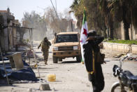 Turkish backed Syrian rebels enter the own of Saraqeb, in Idlib province, Syria, Thursday, Feb. 27, 2020. Turkey-backed Syrian opposition fighters Thursday retook a strategic northwestern town iof Saraqeb, opposition activists said, and cut off the key highway linking the capital, Damascus, with the northern city of Aleppo, days after the government reopened it for the first time since 2012. (AP Photo/Ghaith Alsayed)